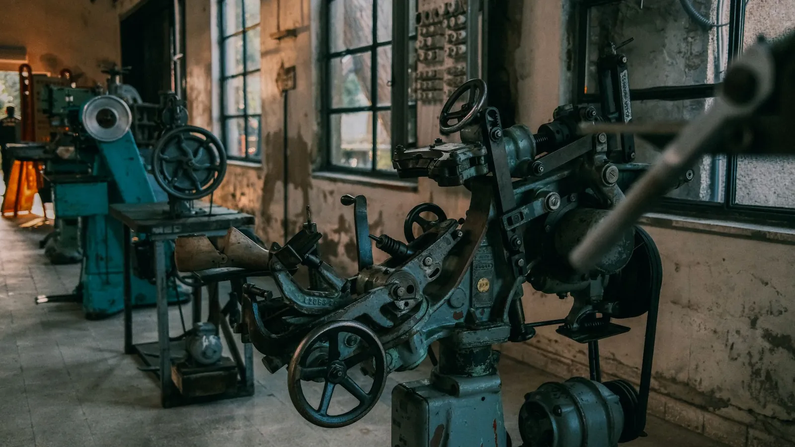Machines-outils conventionnelles à volants de manœuvre alignées dans un atelier ancien