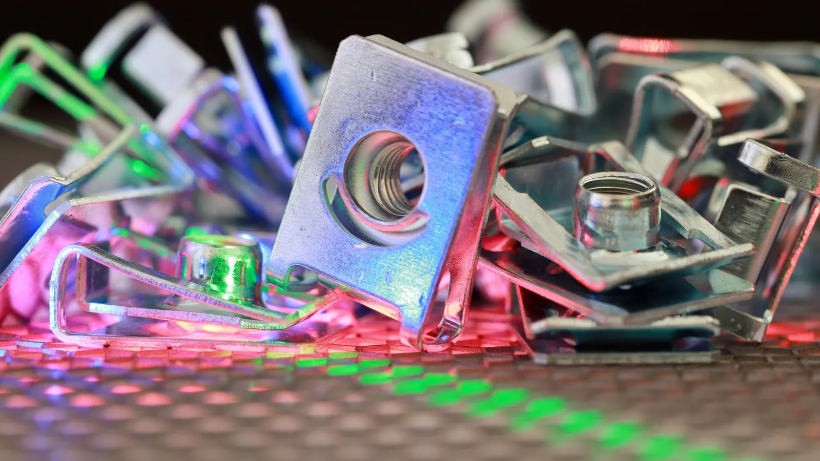 Pièces en tôle d'inox assemblées, cordons fins et réguliers, sur un établi d'atelier
